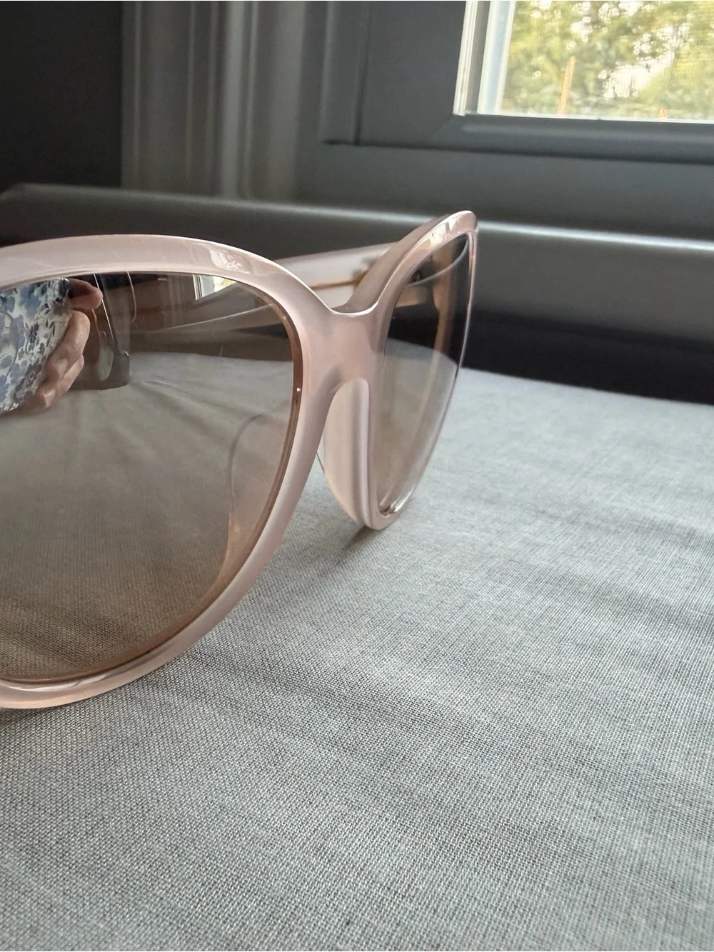 Tory Burch Pale Pink Frame Sunglasses with cat eye shape with gold detail.